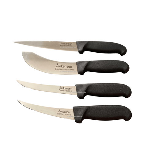 three knives sitting side by side on a black background